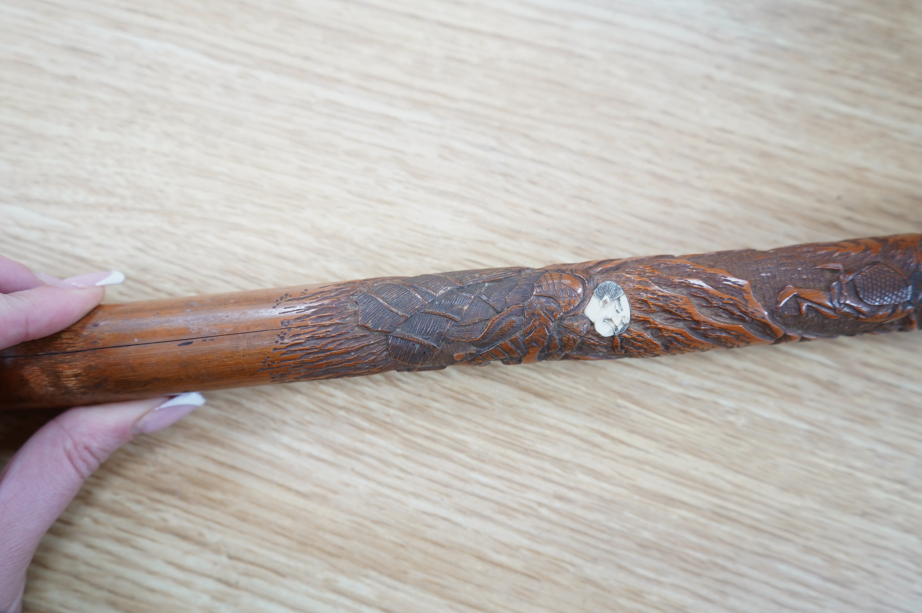 A Japanese carved bamboo walking cane with mother of pearl and ivory inlay. 89.5cm long. CITES Submission reference Submission reference 3UEQCLUL. Condition - fair